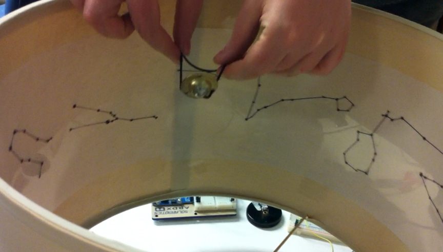 spinning flat projection on lampshade, with metal caster standing in for planet